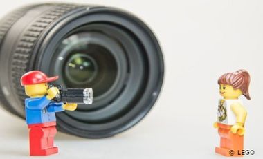 Zwei Legofiguren vor einem Objektiv