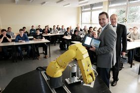 Schüler eines Berufskollegs bei der Ausbildung an einem FANUC-Industrieroboter.