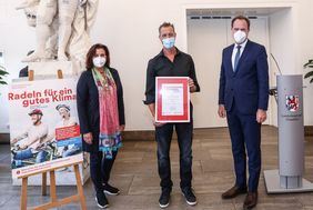 Foto von Oberbürgermeister Dr. Stephan Keller, Umweltdezernentin Helga Stulgies und Frank Strauß (Mitte) vom Familienteam "Grenzenlos unterwegs" 